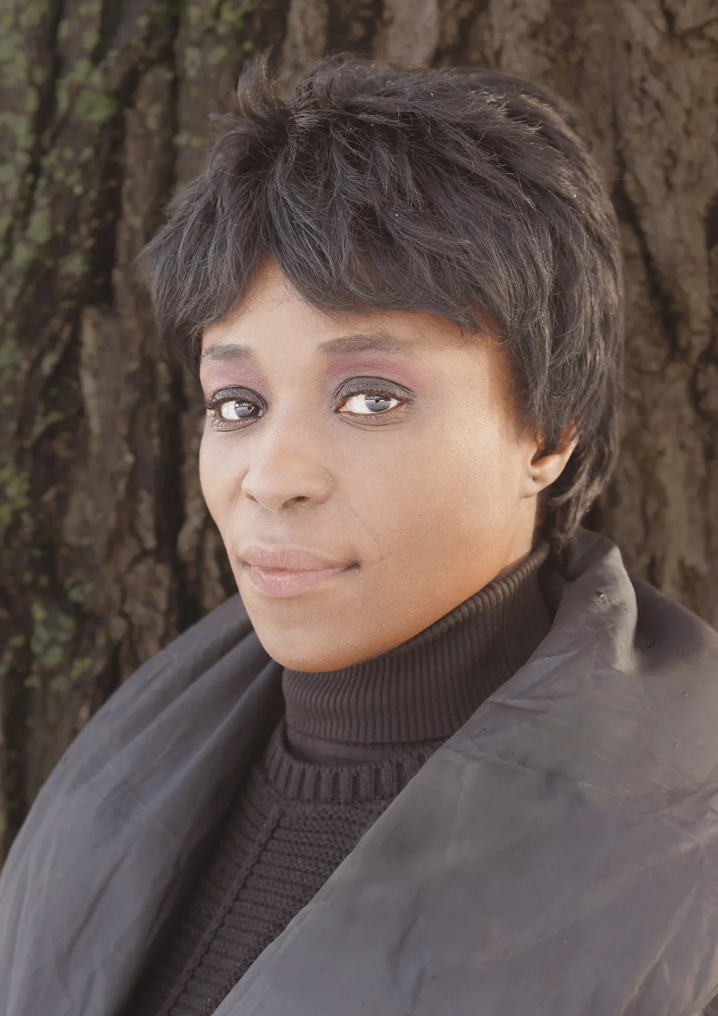 Close-up Portrait of Olga Boto looking in the camera with in the background a tree. Photo by Hinko at Heemraadssingel, Winter 2026